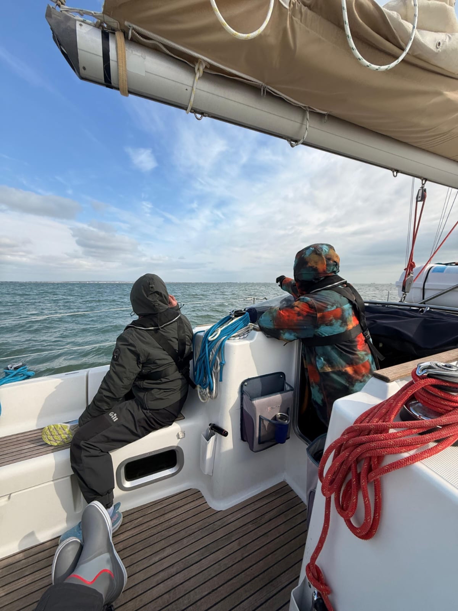 A crew working together in a yacht's cockpit.
